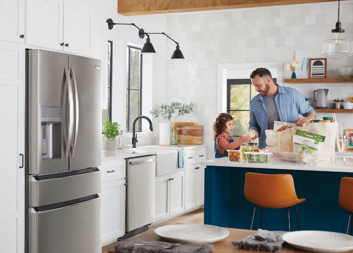 Father and daughter cooking a meal in modern kitchen